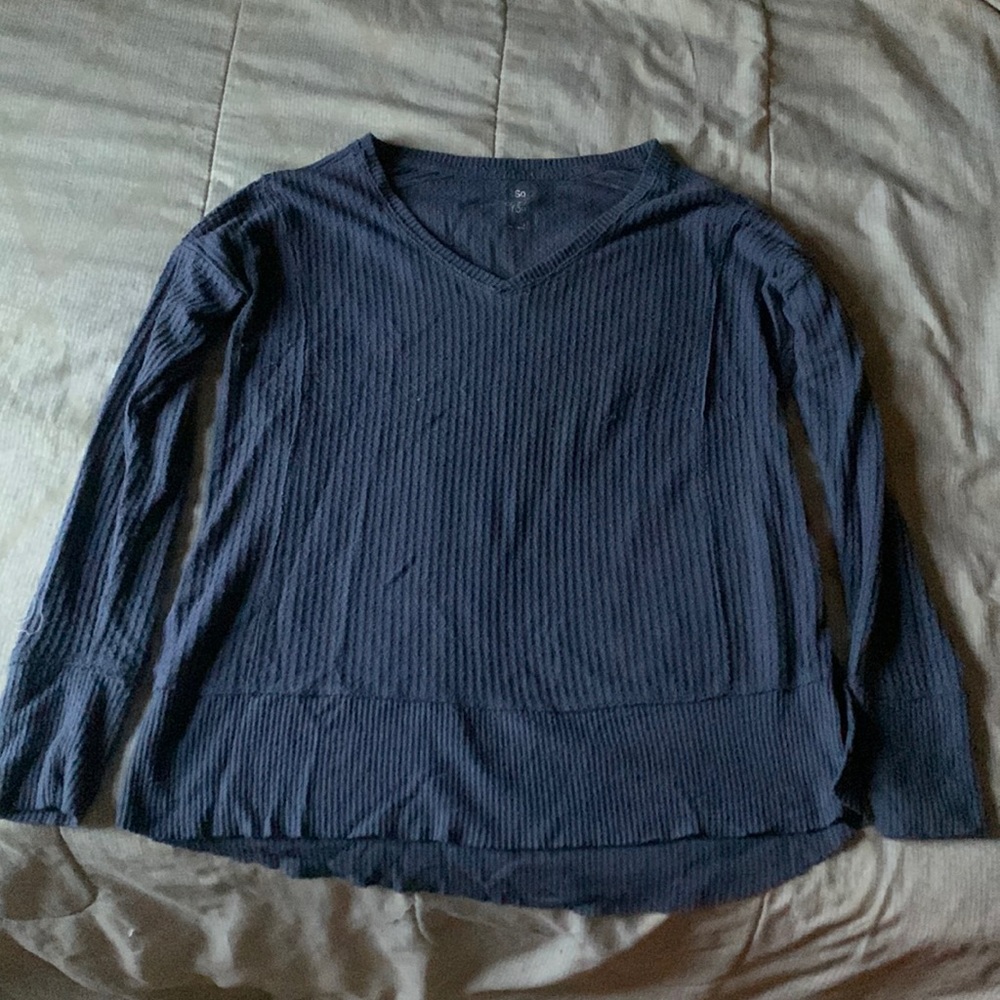 Longer in the back the, size small but fits like a medium